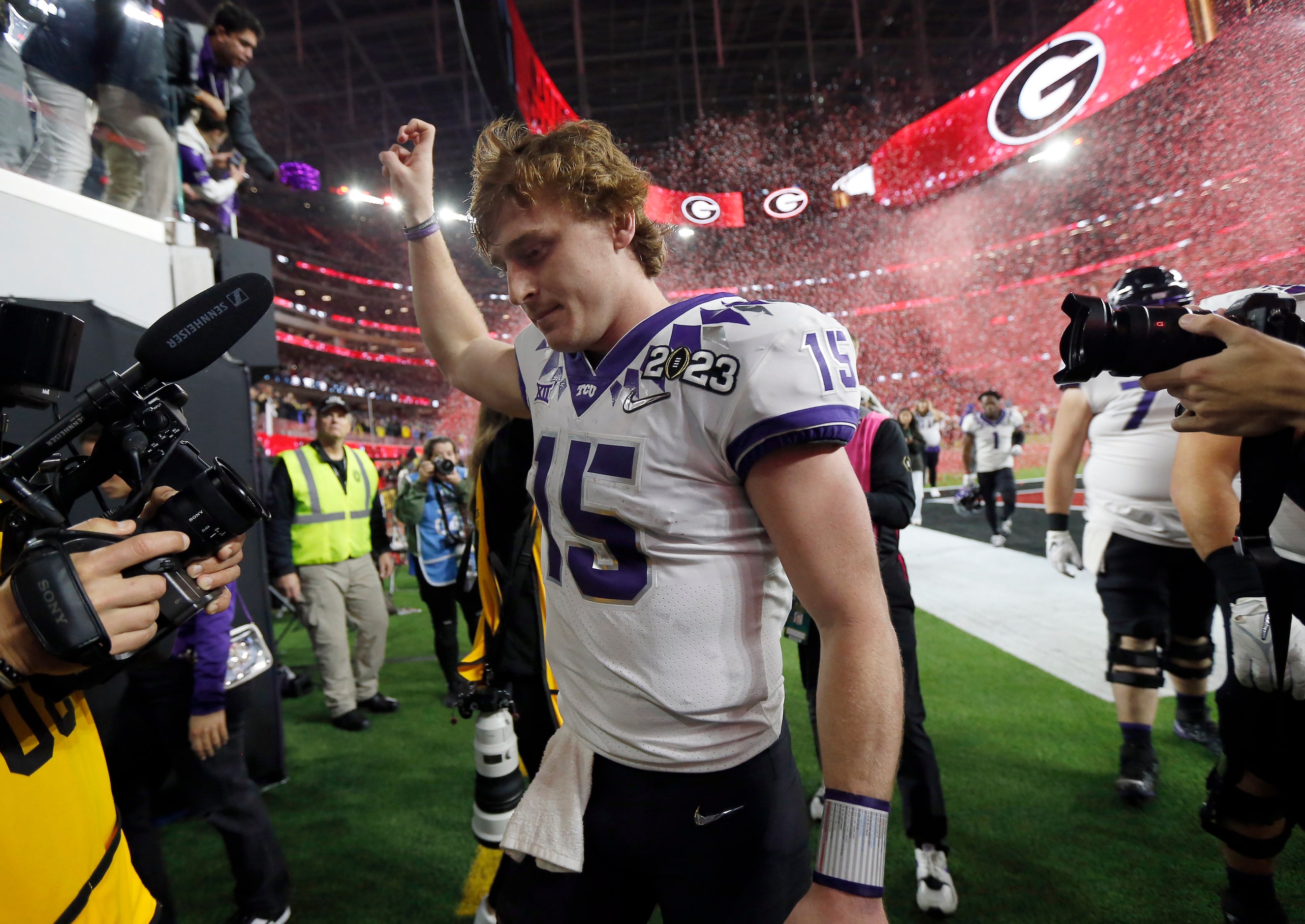 As Georgia Bulldogs red confetti rains down, TCU Horned Frogs quarterback Max Duggan (15)...