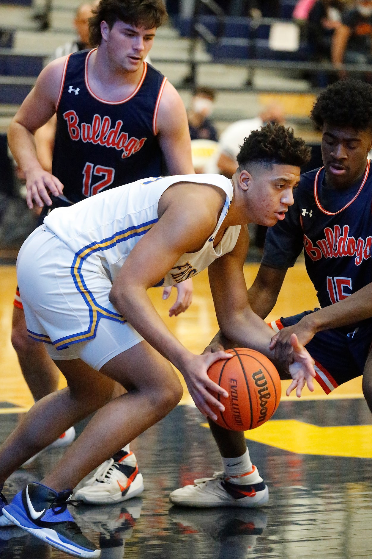 Frisco High School Jovani Benae (23) controls a loose ball in front of McKinney North High...