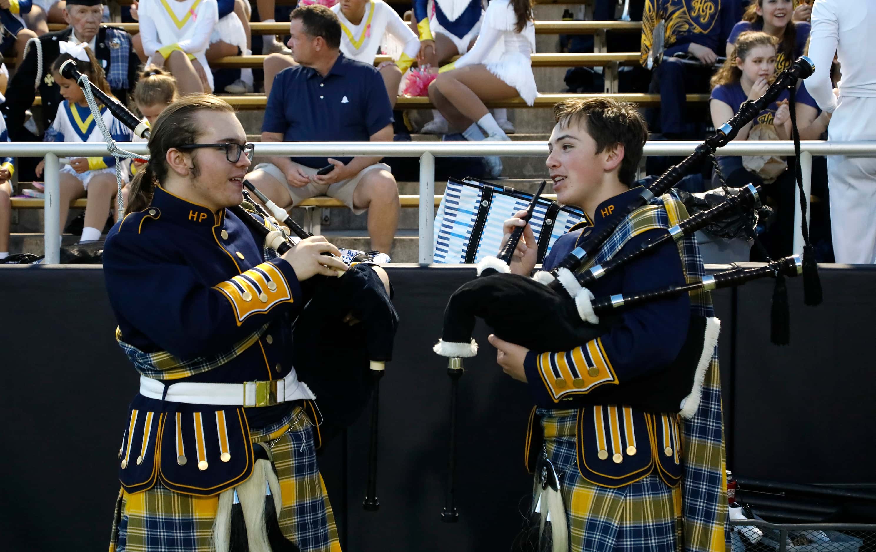 Highland Park High School bagpipers Gage Swords (left), 15, and Jake Wood, 15, warm up...
