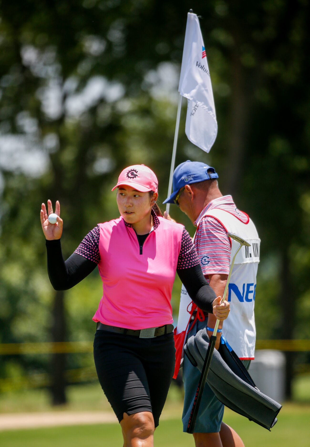 Professional golfer Min-G Kim waves to the crowd after making par on the 17th hole during...