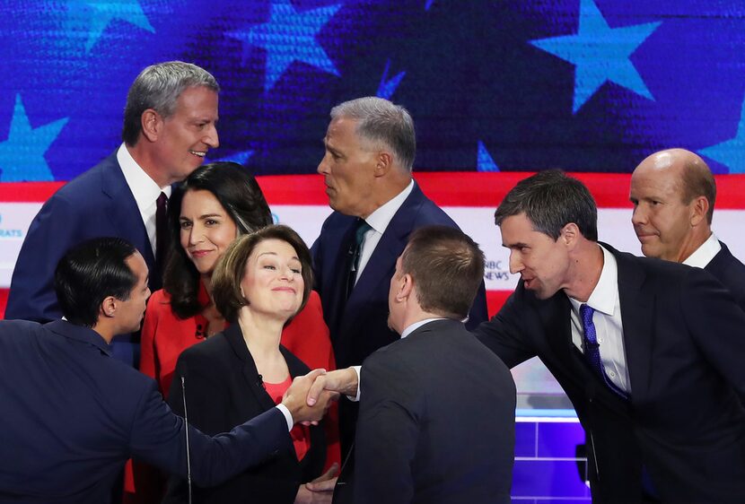 Julian Castro and Beto O'Rourke shake hands after the first Democratic presidential debate...