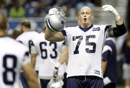 FILE - Marc Colombo (75) jokes with a teammate during Cowboys training camp at the Alamodome...
