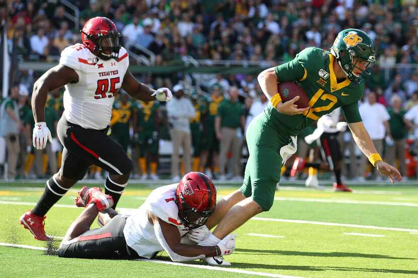 WACO, TEXAS - OCTOBER 12: Jordyn Brooks #1 of the Texas Tech Red Raiders tackles Charlie...