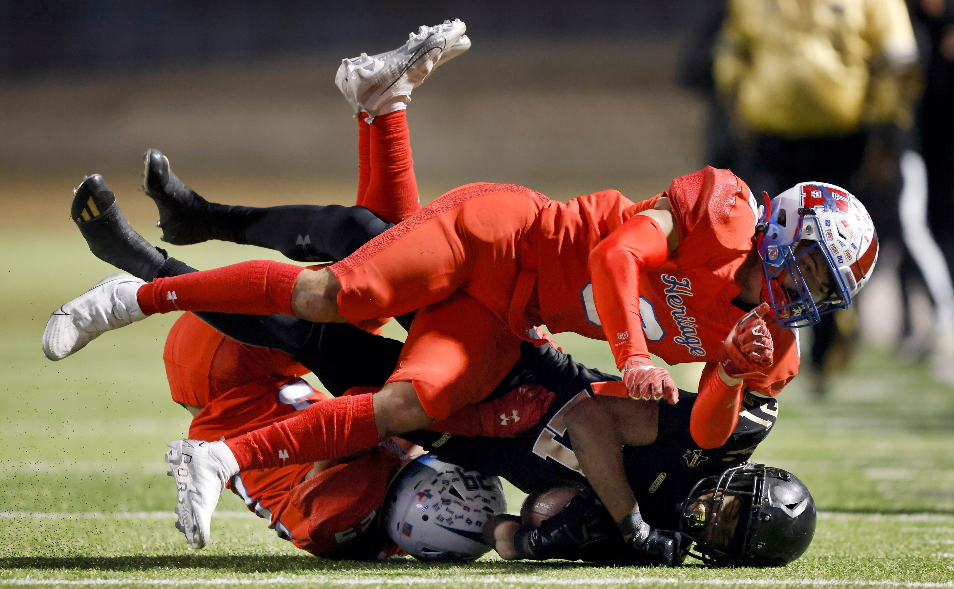 South Oak Cliff running back Danny Green (21) is tackled by Midlothian Heritage linebacker...