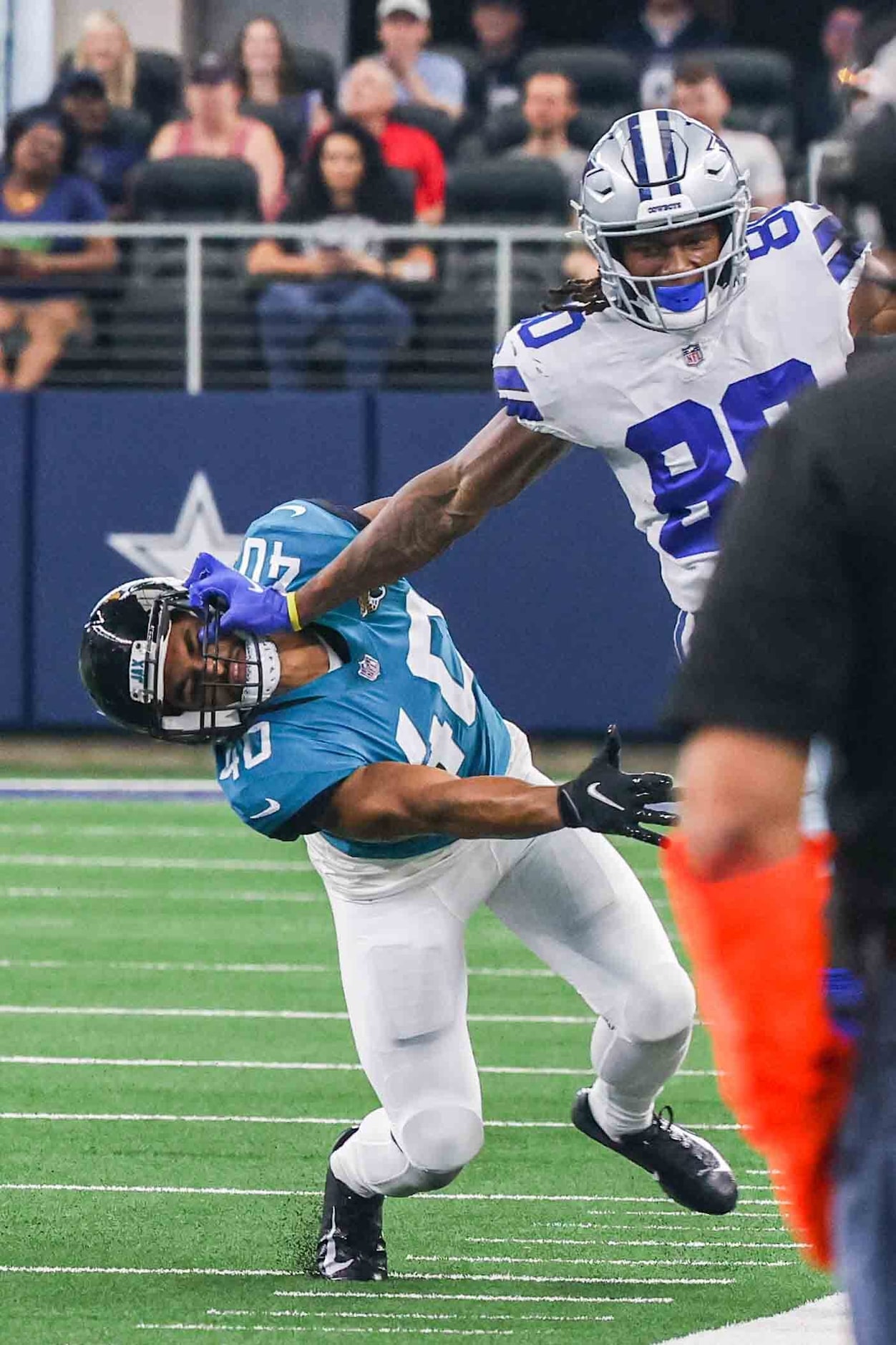 Dallas Cowboys wide receiver Brandon Smith, 80, pushes Jacksonville Jaguars' Brandon Rusnak,...