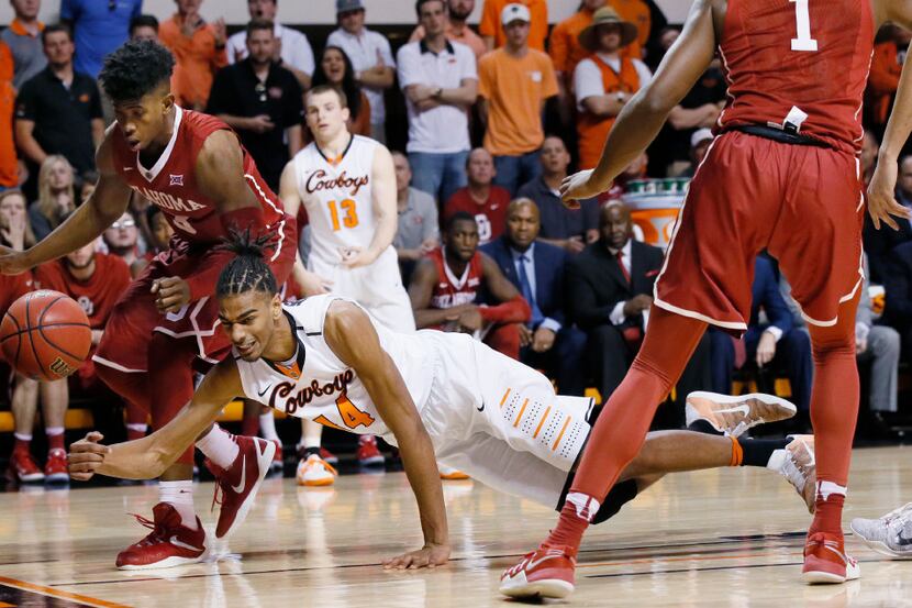 Oklahoma State forward Lucas N'Guessan (14) dives for a ball in front of Oklahoma guard...
