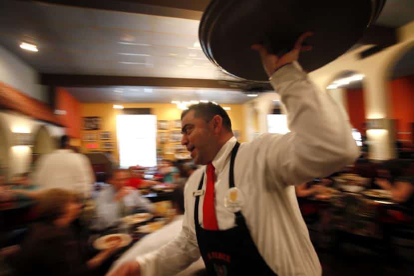 El Fenix waiter Ulises Garcia worked at the downtown Dallas location last week. The company...