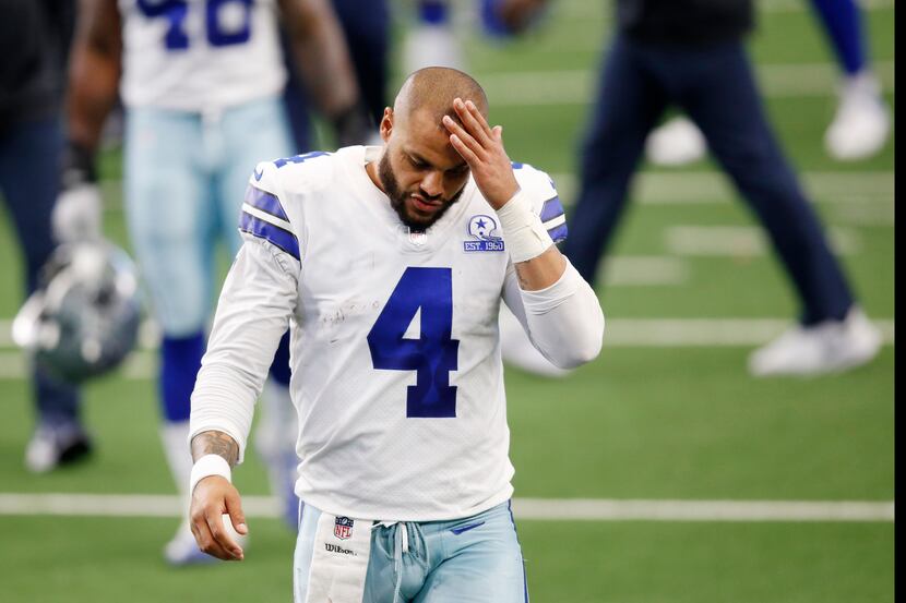 Dallas Cowboys quarterback Dak Prescott (4) makes his way off the field after losing to the...
