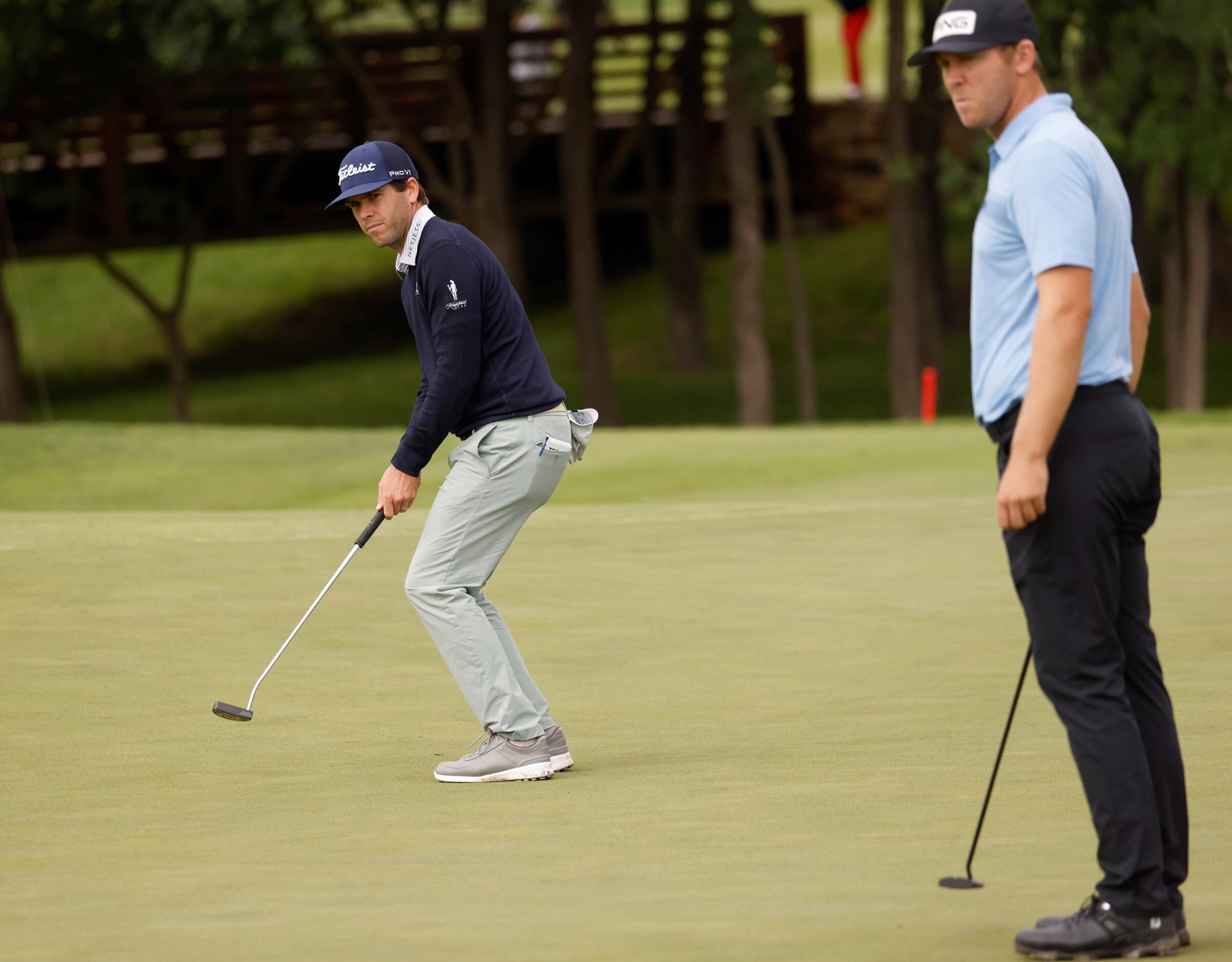 Ben Martin reacts as he watches his putt in front of Seamus Power (right) on the 12th hole...