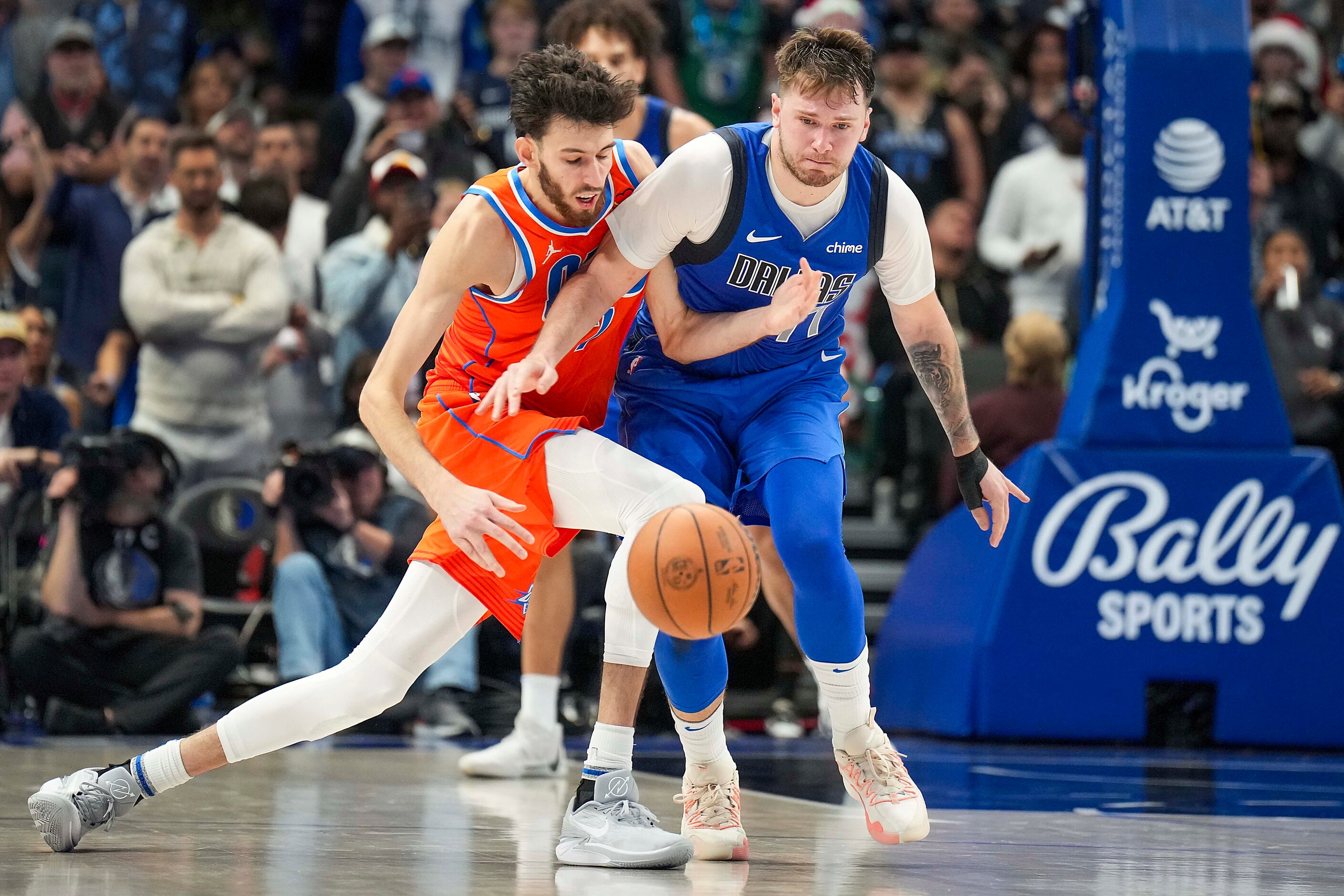 Dallas Mavericks guard Luka Doncic (77) steals the ball from Oklahoma City Thunder forward...