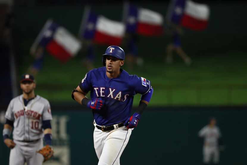 ARLINGTON, TEXAS - JULY 12:  Ronald Guzman #11 of the Texas Rangers runs after a two-run...