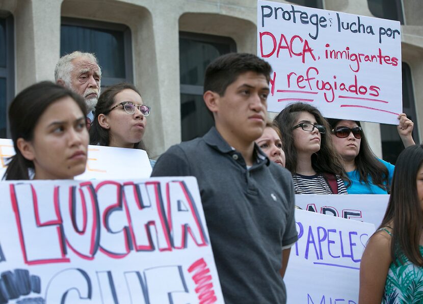 Several people gathered on the plaza of the J.J.Pickle Federal Building in Austin on Tuesday...