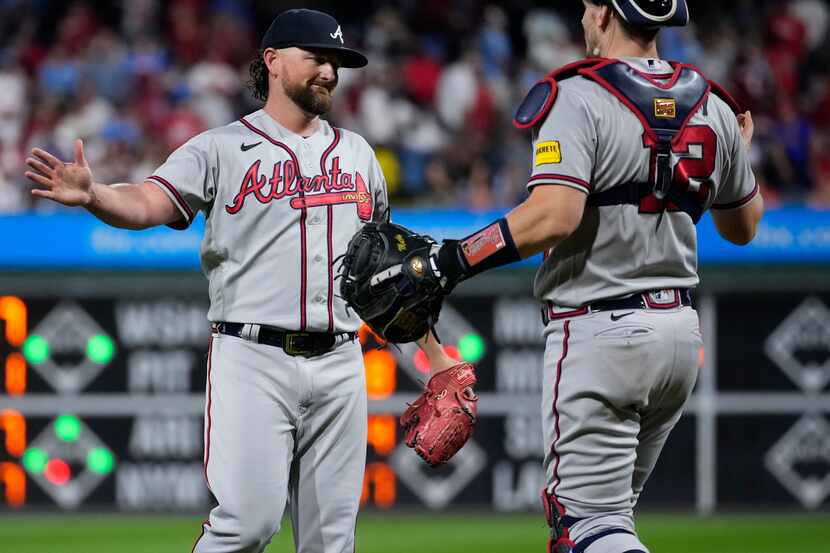 Atlanta Braves' Kirby Yates celebrates with Sean Murphy after the Braves clinched their...