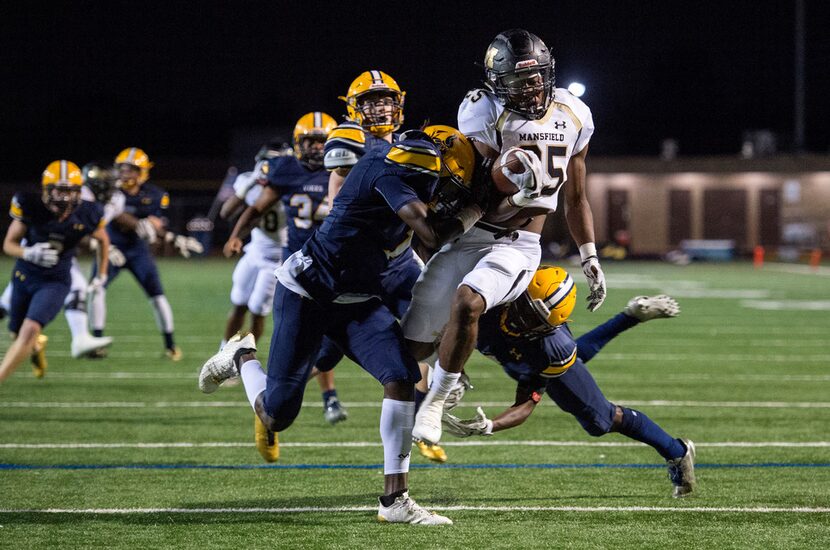 FILE - Mansfield senior running back Jaqulis Coleman (25) is hit by Arlington Lamar...