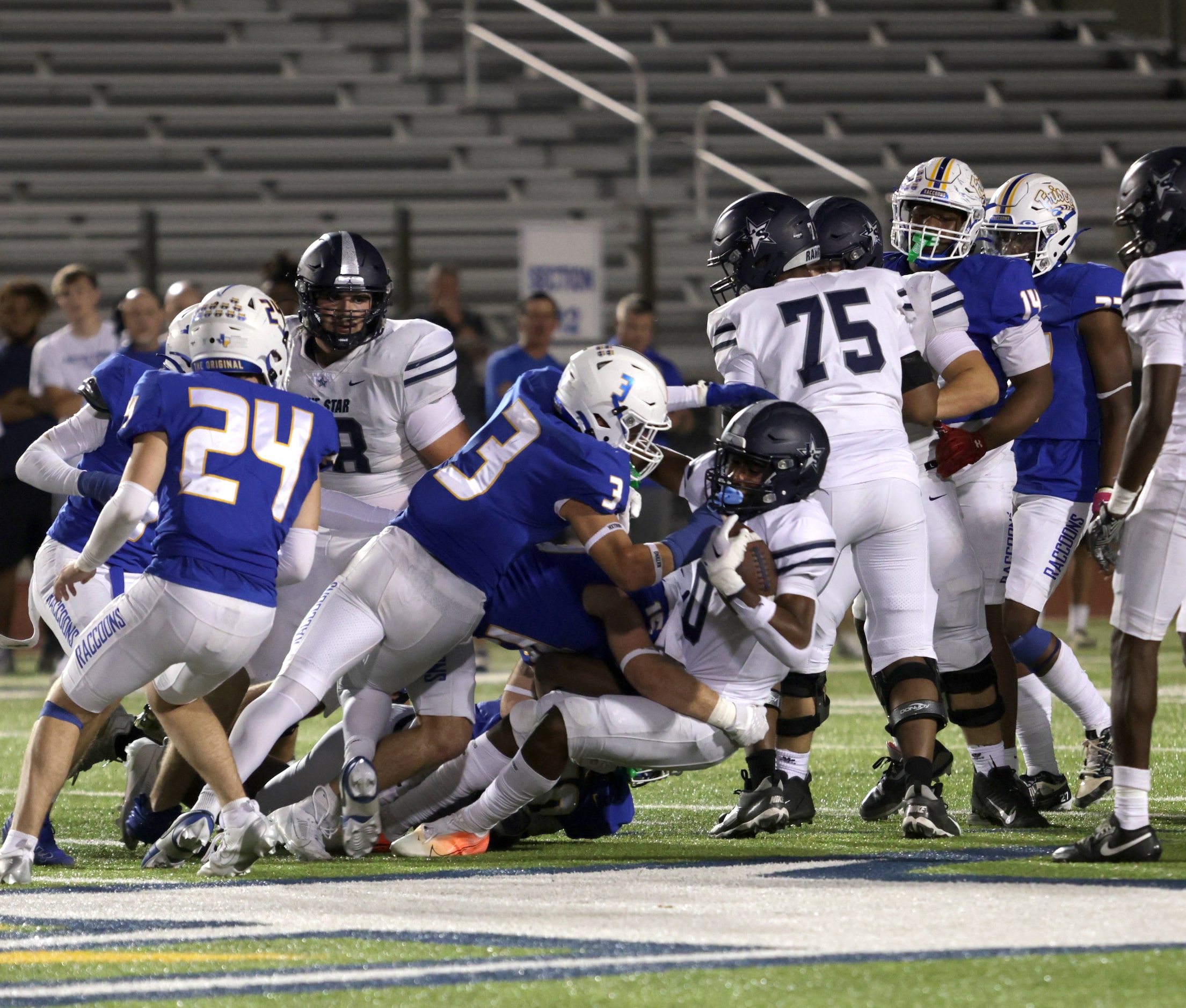 Lone Star player #0 Davian Groce is taken down by several Frisco players during the Frisco...