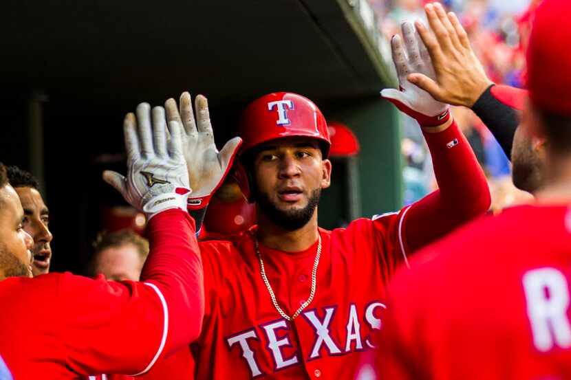 Texas Rangers right fielder Nomar Mazara (30) celebrates a run with teammates during the...