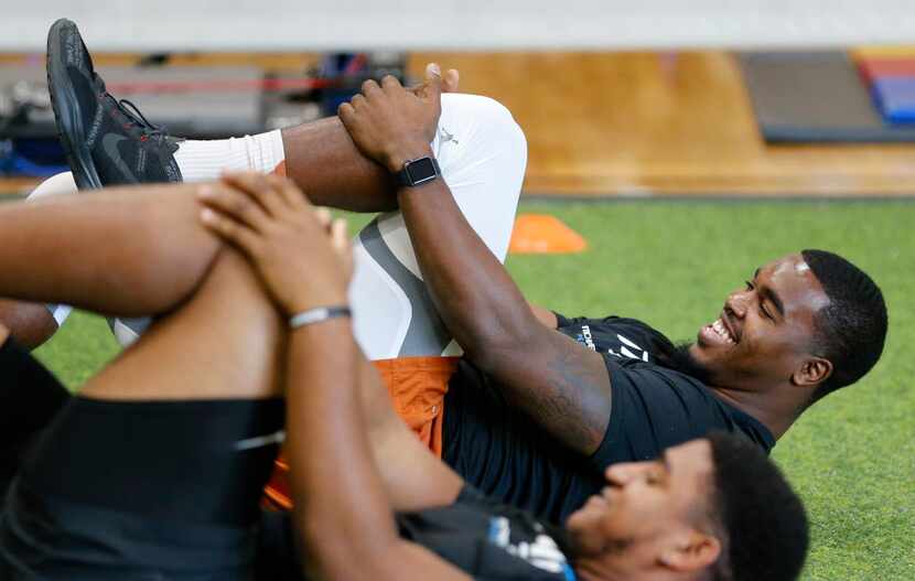 Texas' Tyrone Swoopes smiles as he stretches before working out at Michael Johnson...