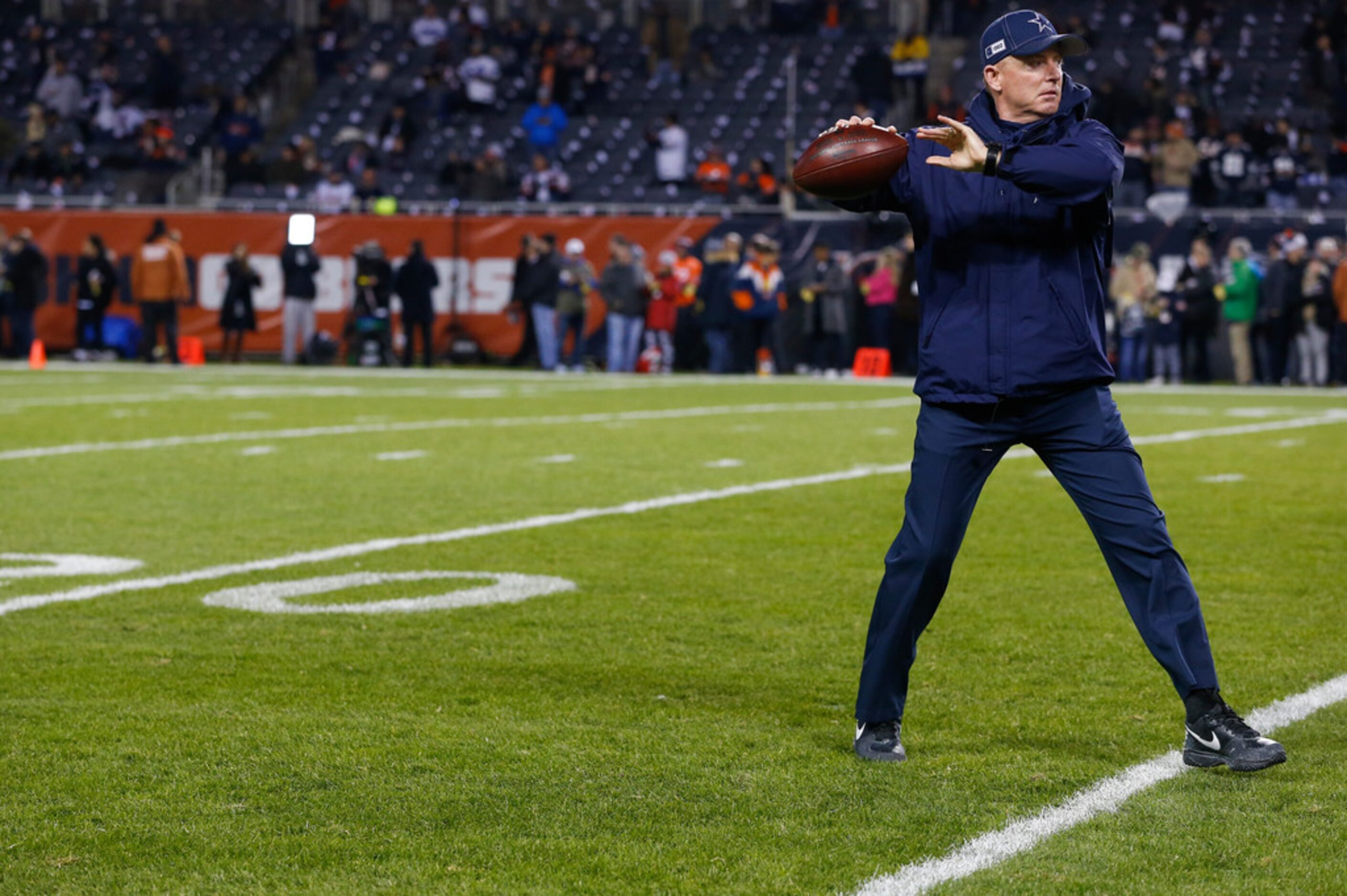 Dallas Cowboys head coach Jason Garrett fires off a warmup pass prior to a NFL matchup...