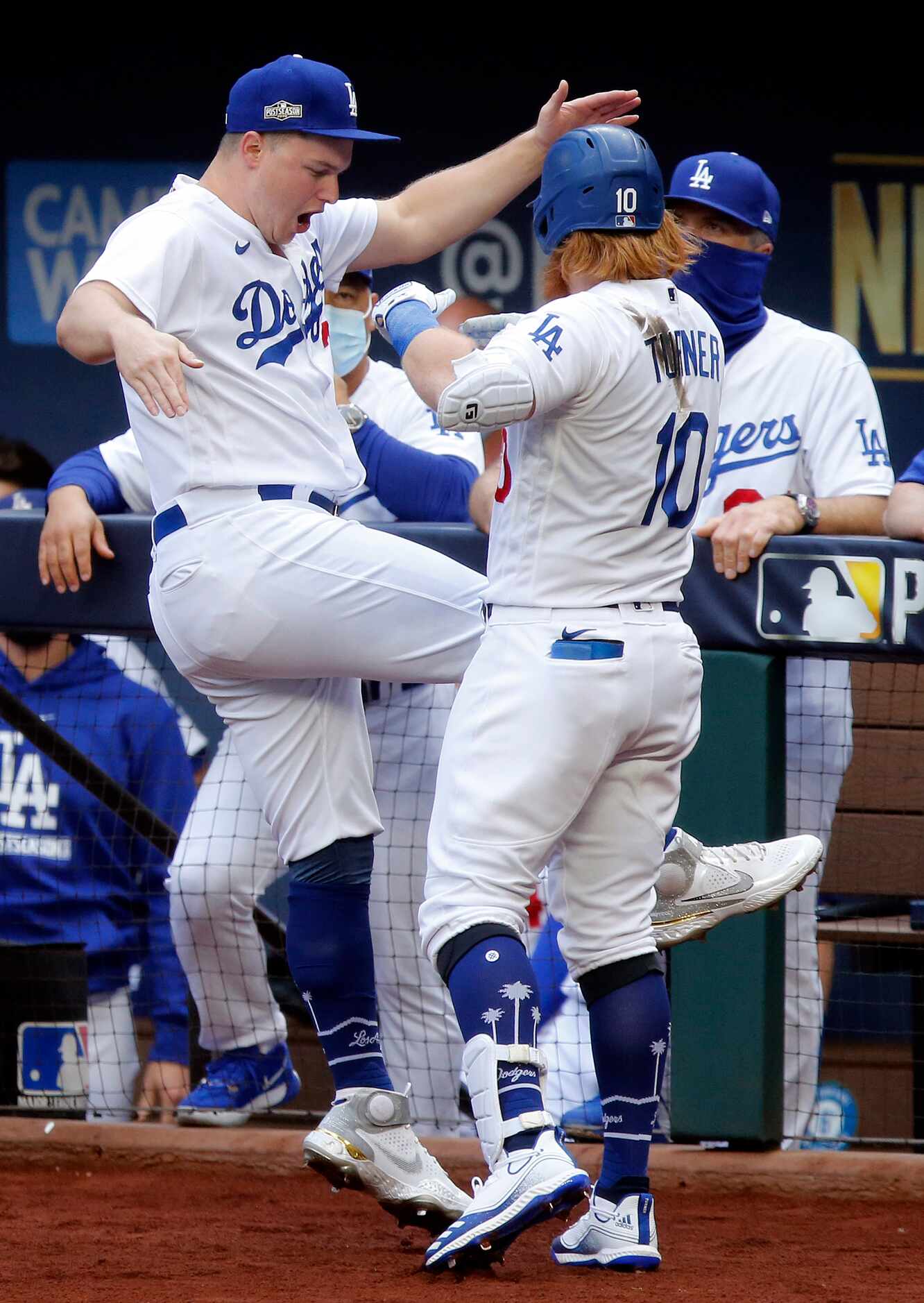 Los Angeles Dodgers Justin Turner (10) is congratulated on his first inning solo home run by...