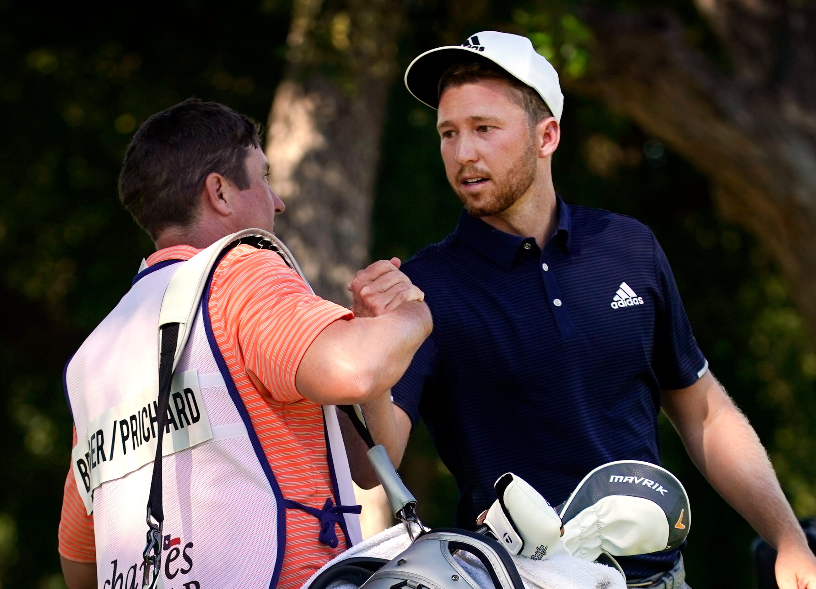 PGA Tour golfer Daniel Berger (right) is congratulated by his caddie Grant Barry after...