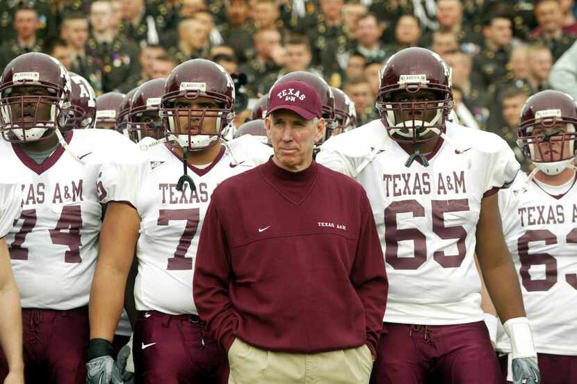 FILE - Texas A&M head coach R. C. Slocum (center) and the Aggies prepare to take the field...