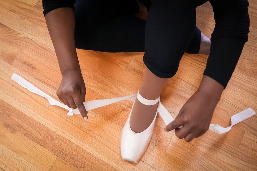Nikki Delk, a professor at UT Dallas who conducts cancer research, laces her pointe shoe...