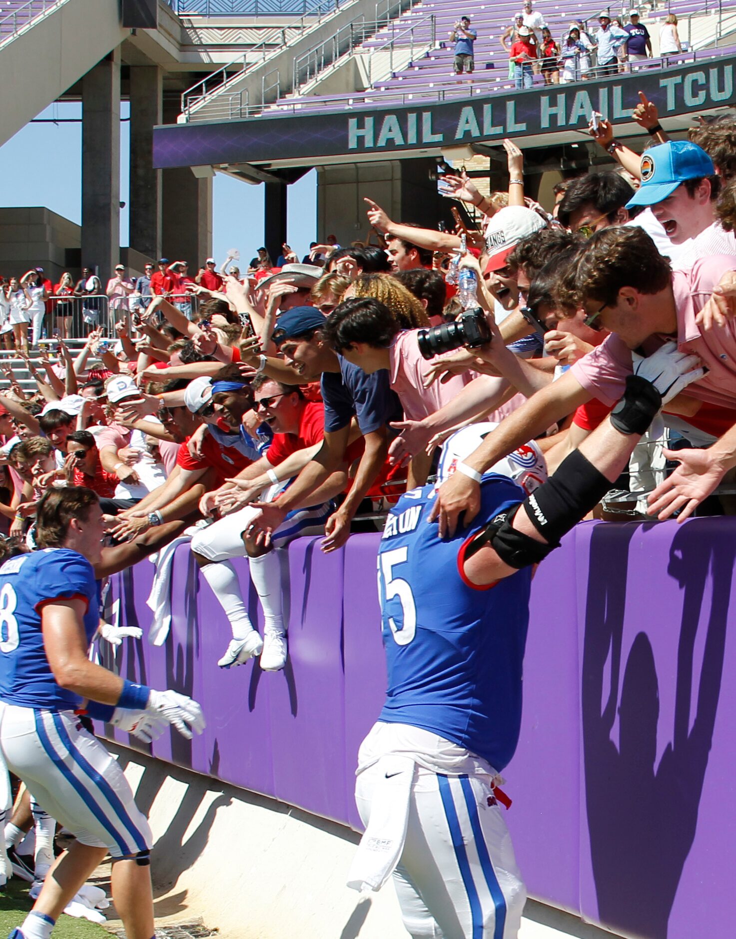 SMU offensive lineman Hayden Howerton (75) foreground, celebrates with fans following the...