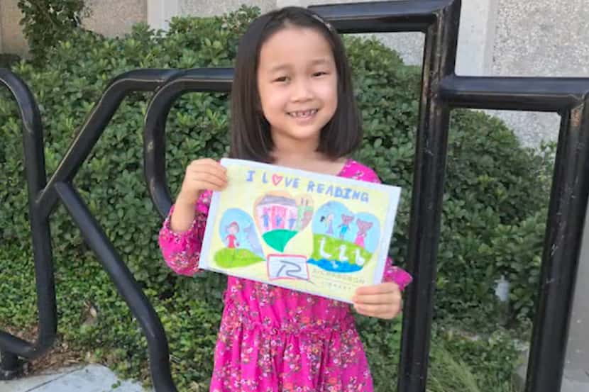Ardent Lee, 7, is the winner of the Richardson Public Library's children's library card...
