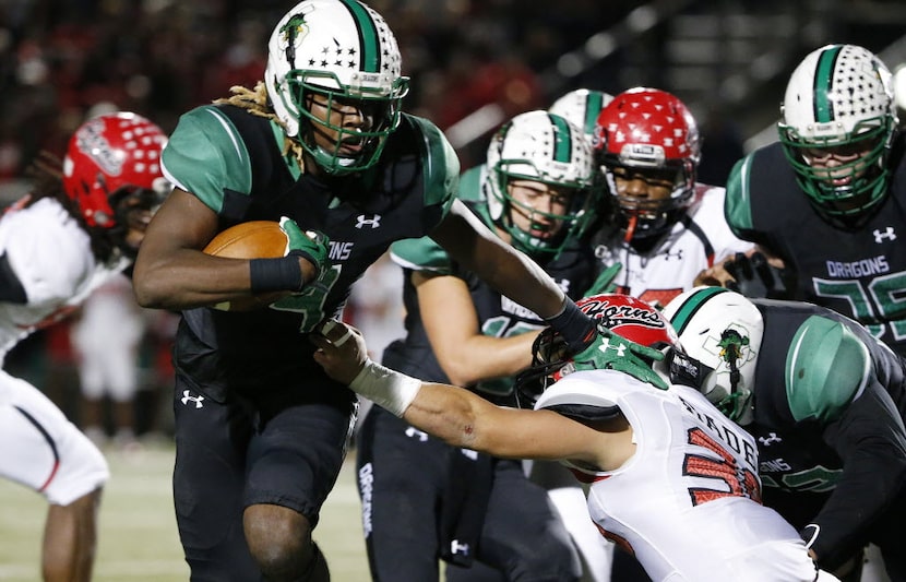 Southlake Carroll running back Lil' Jordan Humphrey (4) carries the ball in the first half...