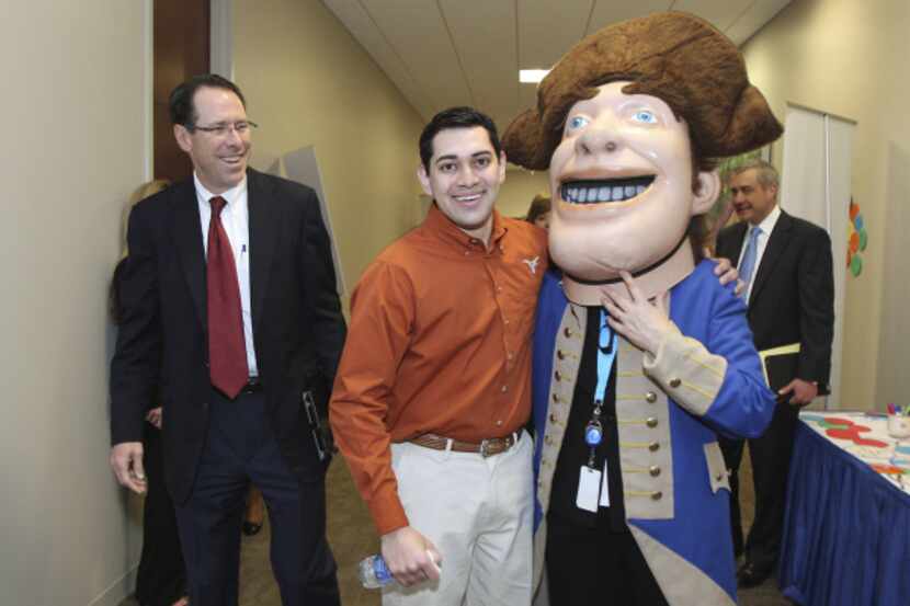 Alex Elizardo (center) goofs around with the mascot of Thomas Jefferson High School in...