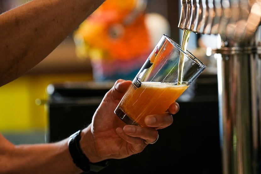 George Esquivel pulls a pint of beer at Four Corners Brewing Co. in Dallas' Cedars...
