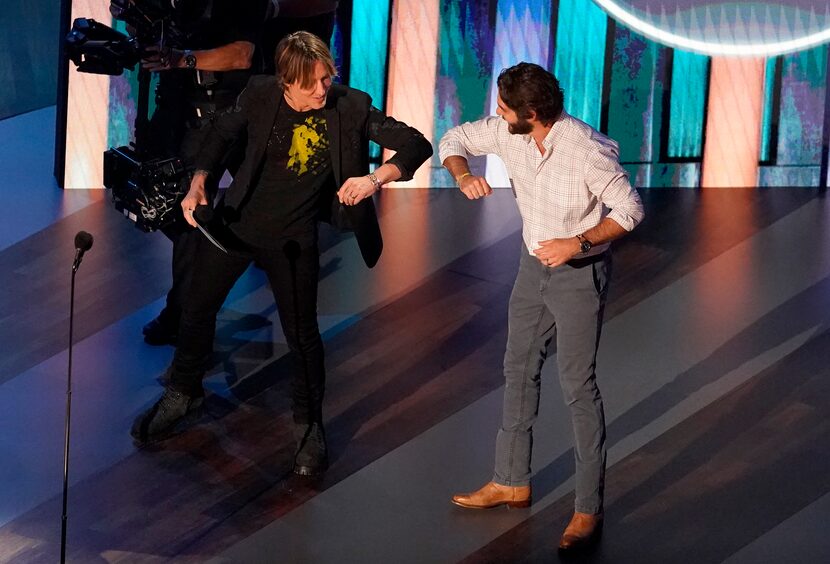 Thomas Rhett (right) got an elbow bump from host Keith Urban on stage at the Grand Ole Opry.