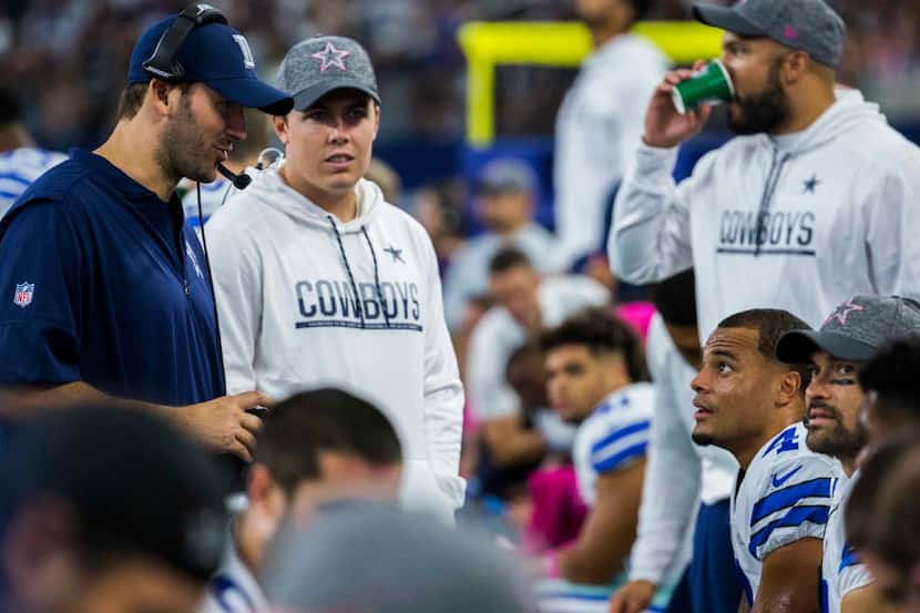 Dallas Cowboys quarterback Tony Romo (9) talks to quarterback Dak Prescott (4) after...