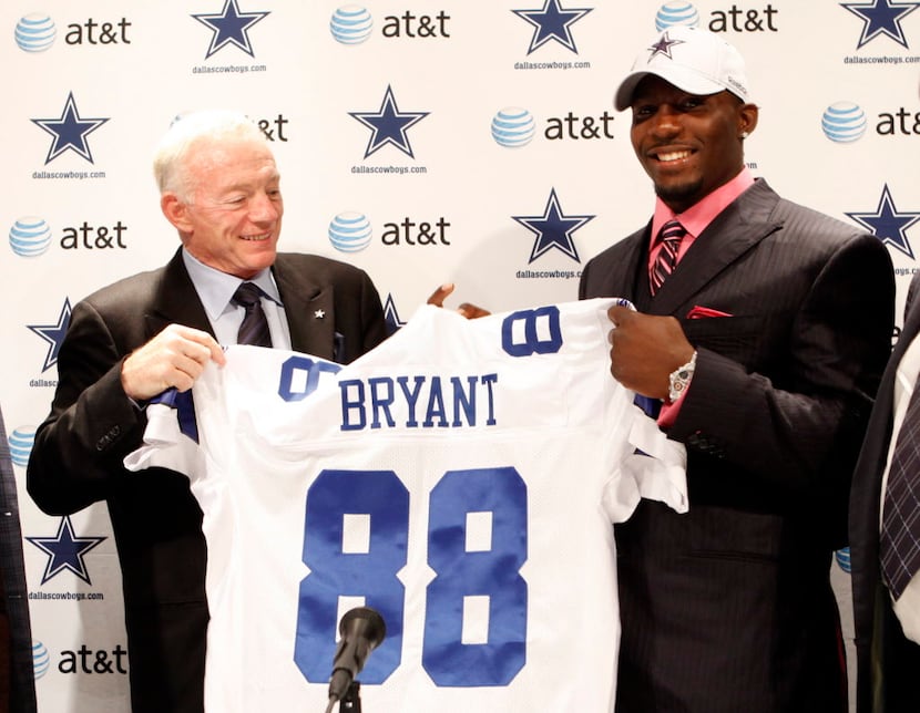 Dallas Cowboys owner Jerry Jones and first round draft pick Dez Bryant hold up Bryant's...