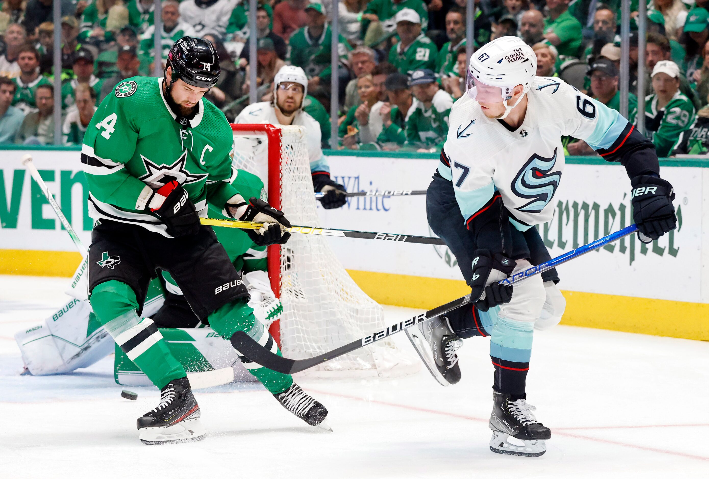 Seattle Kraken center Morgan Geekie (67) backhands a pass past Dallas Stars left wing Jamie...