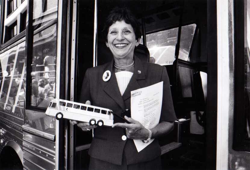 Adlene Harrison showed off a miniature version of one of DART's new express buses in 1984.