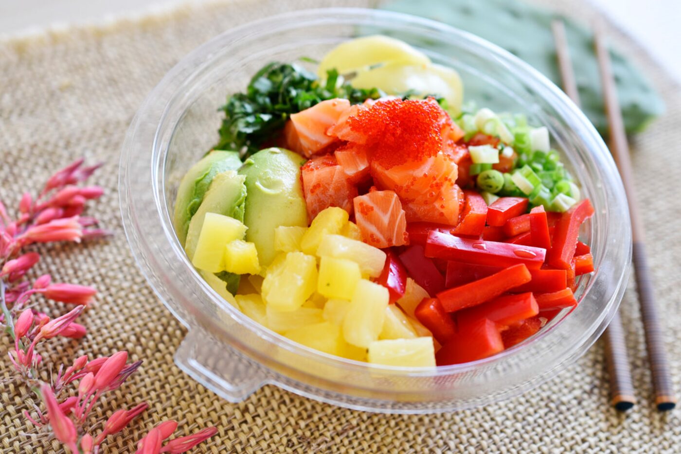 Mediterranean salmon bowl with couscous, daikon, pineapple, sweet onion, green onion, mint,...