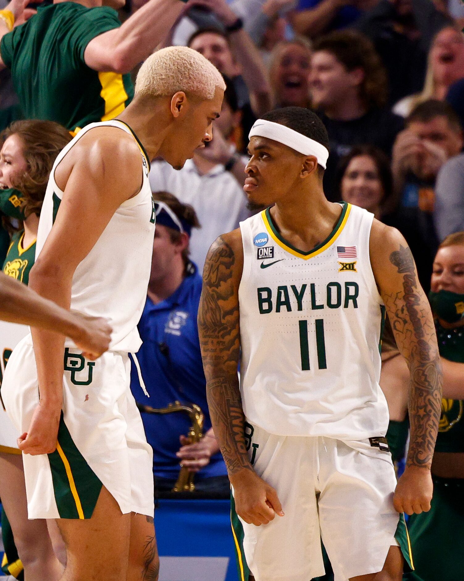 Baylor Bears guard James Akinjo (11) and Baylor Bears forward Jeremy Sochan (1) react after...