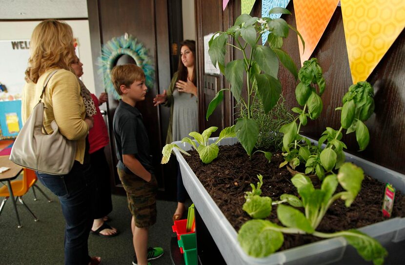 
Christina Briseno (right) of Dallas, lead teacher for Elementary 1, talks about the...