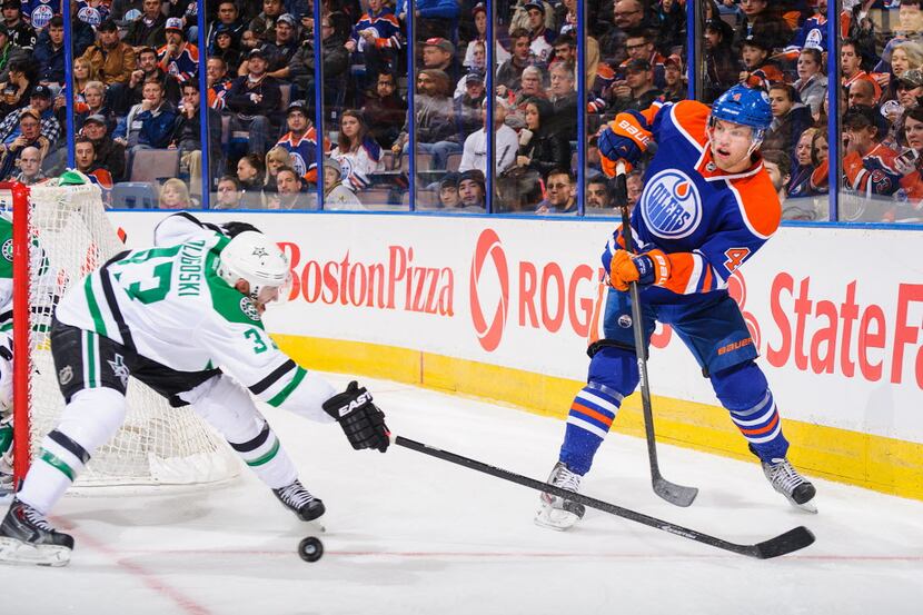 EDMONTON, AB - NOVEMBER 13: Taylor Hall #4 of the Edmonton Oilers passes the puck past the...