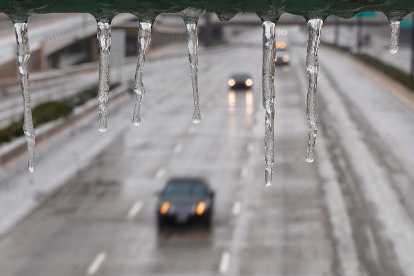 Cars drive down US-75 despite the icy road conditions, Wednesday, Feb. 1, 2023, in Dallas....