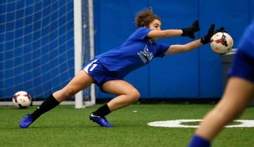 Lilly Heit blocks a shot during soccer practice at Frisco High School.