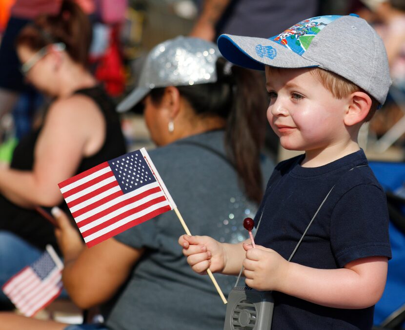 Lucas Maxon, 2, of Rowlett observes Garland's annual Labor Day Parade in downtown Garland in...