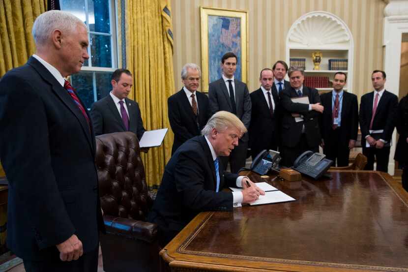 President Donald Trump signed executive orders in the Oval Office on Monday, his first...