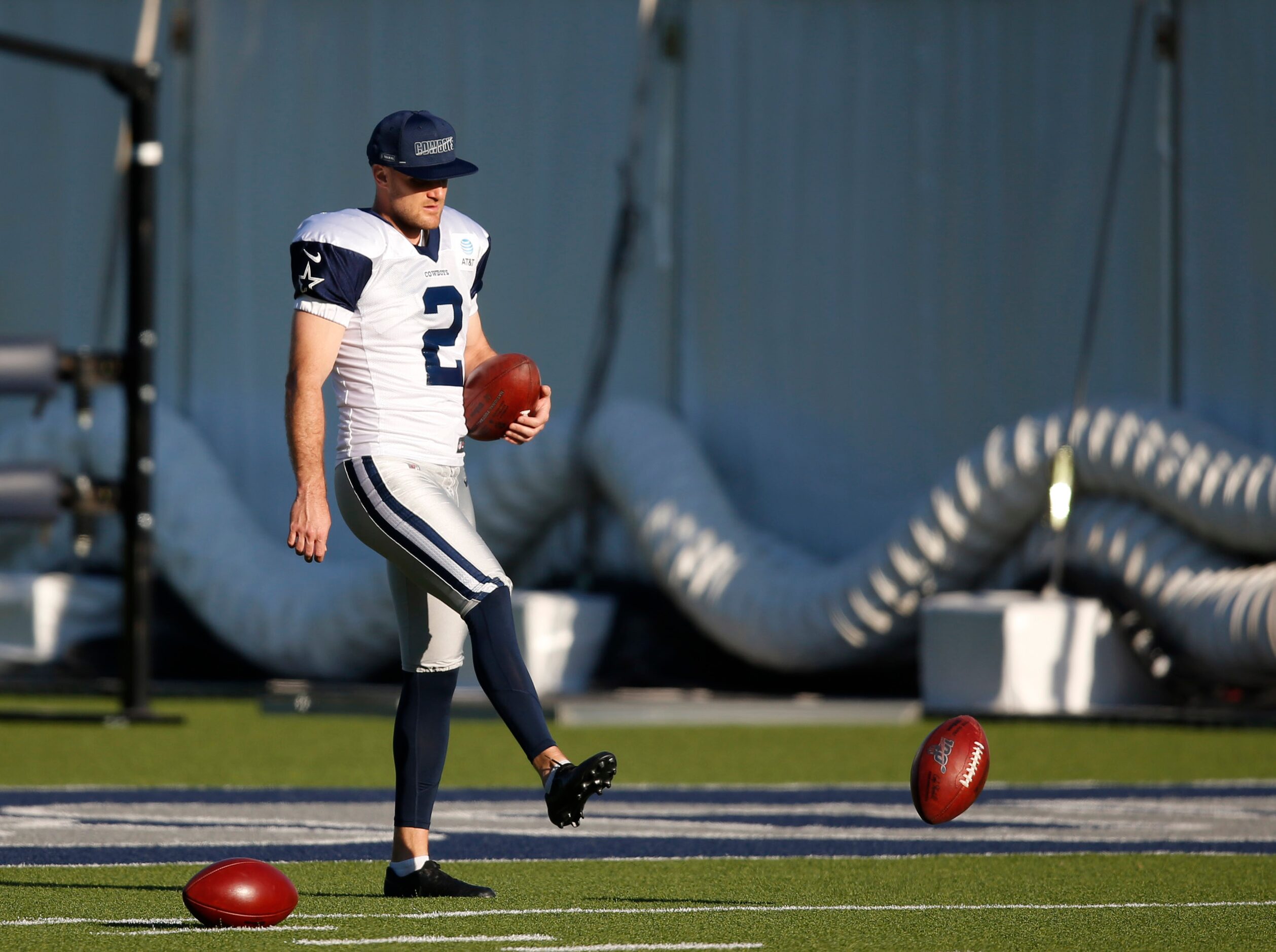 Dallas Cowboys place kicker Greg Zuerlein (2) gathers footballs in practice during training...