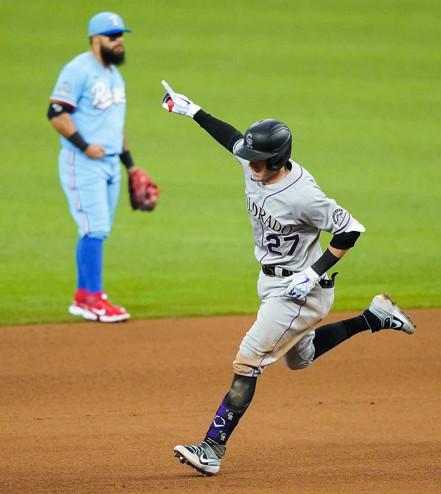 Colorado Rockies shortstop Trevor Story rounds the base past Texas Rangers second baseman...