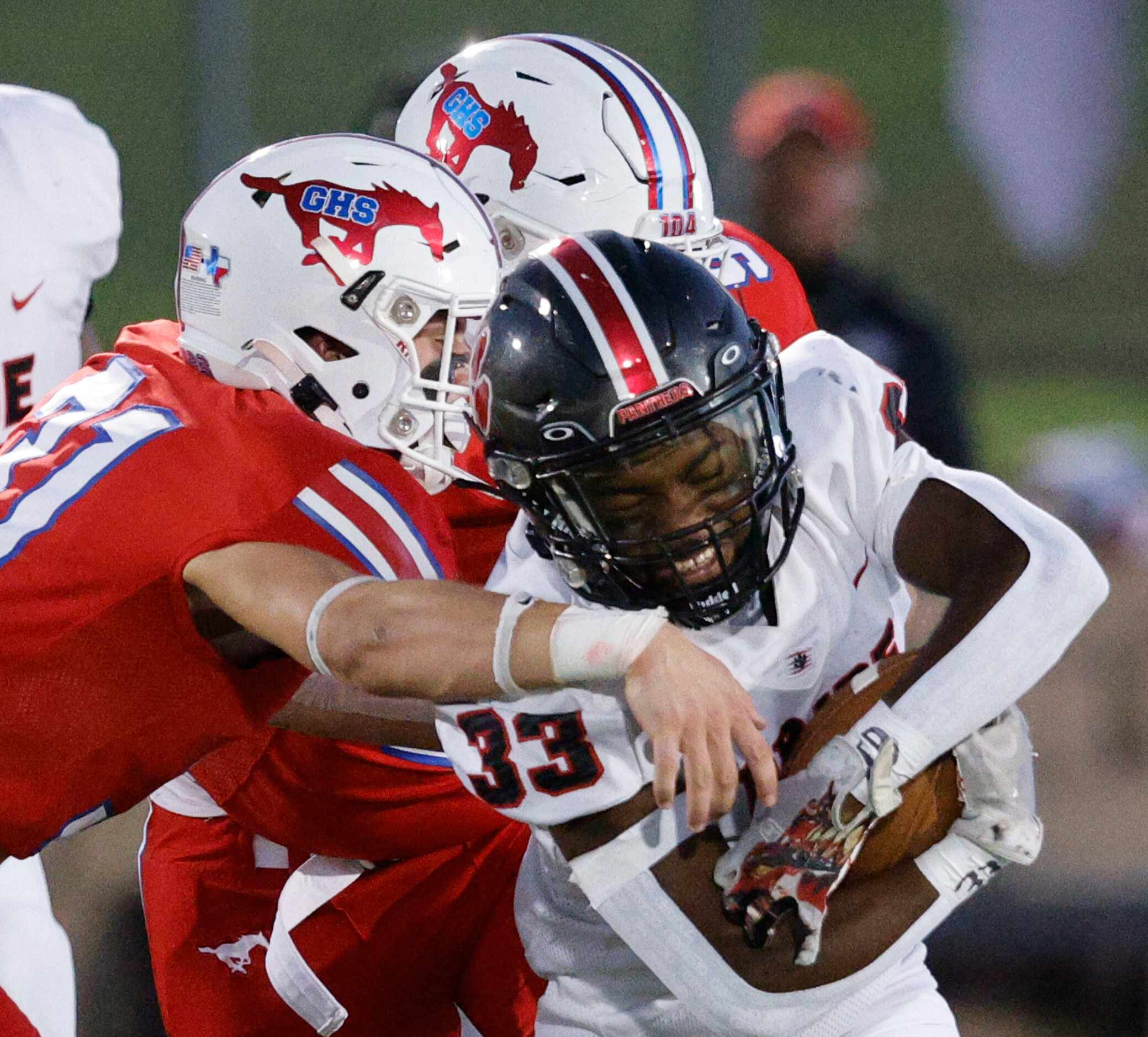 Colleyville Heritage's Colin Bennett (33) keeps a ball away from Grapevine's Cooper Towery...