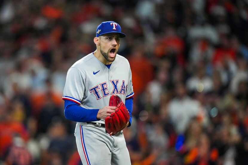 Texas Rangers starting pitcher Nathan Eovaldi celebrates after a groundout by Houston Astros...