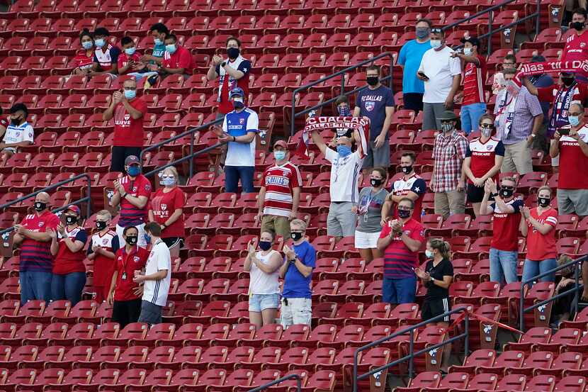 FC Dallas supporters cheer as their team takes the field before an MLS soccer game against...