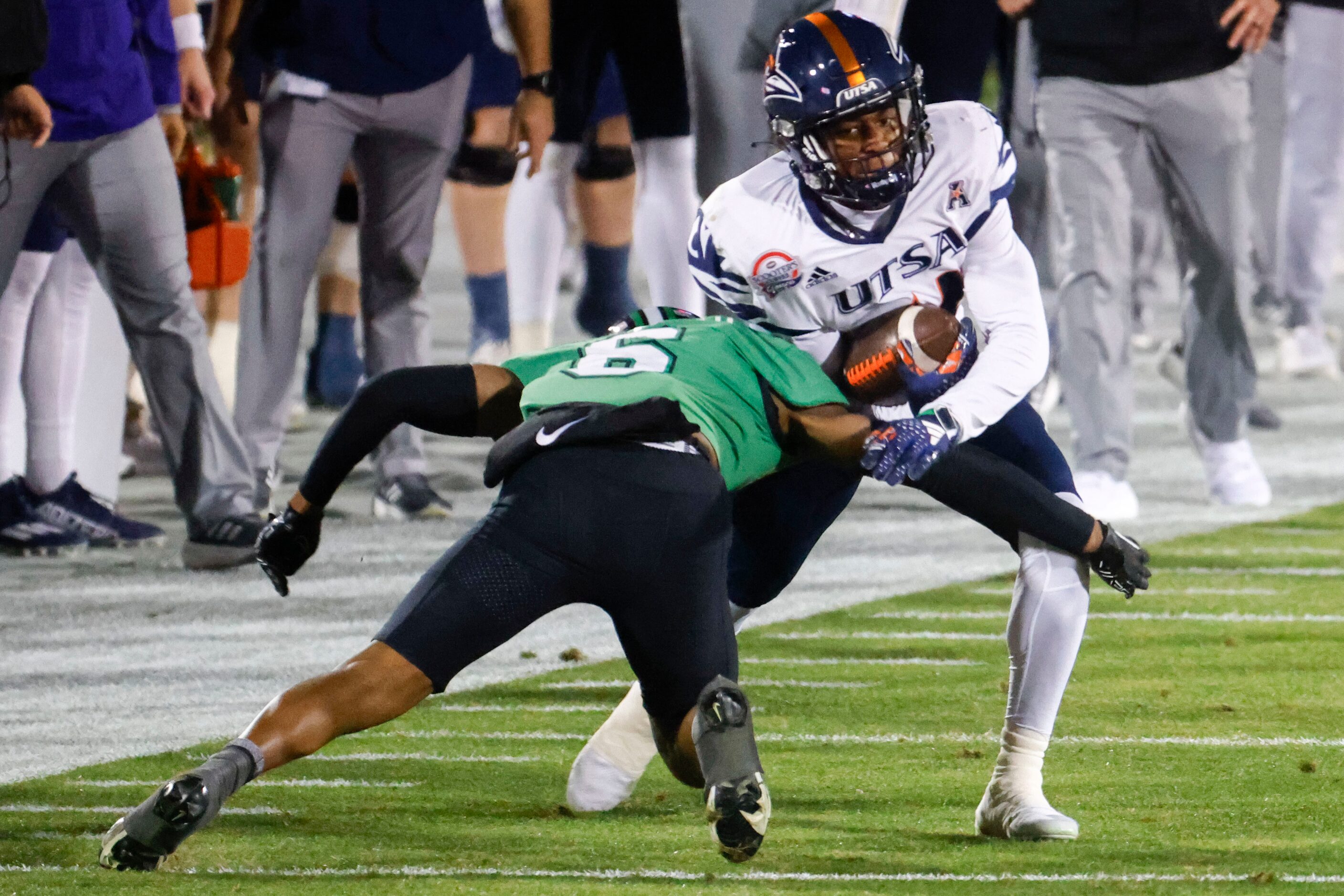 Marshall defensive back Micah Abraham (front) tackles UTSA wide receiver Devin McCuin as he...